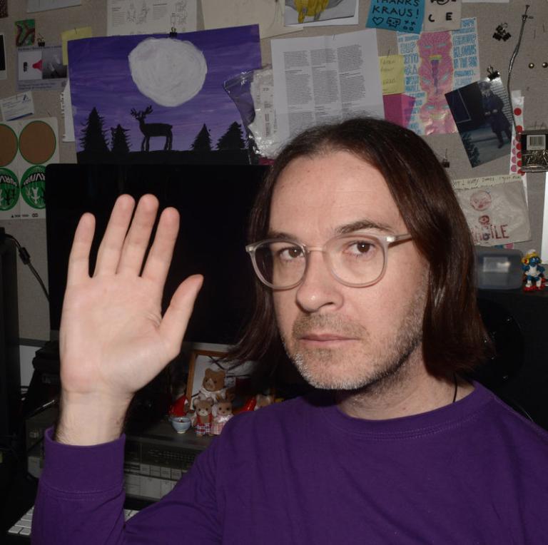 A selfie of Kraus, waving at the viewer