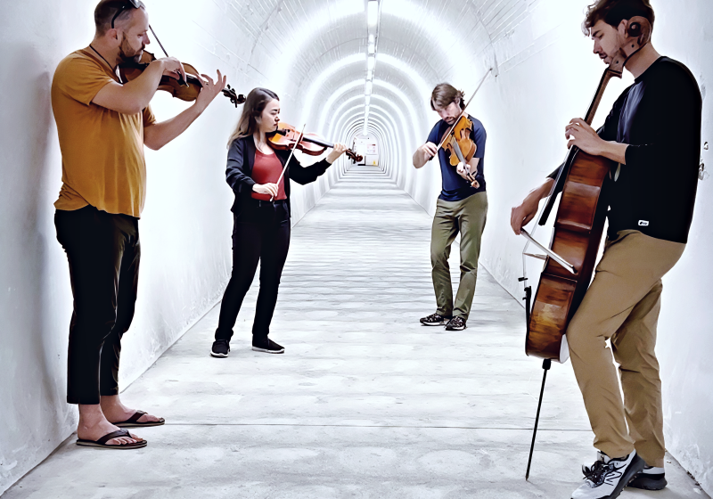 4 Composers in a tunnel with bright white lights