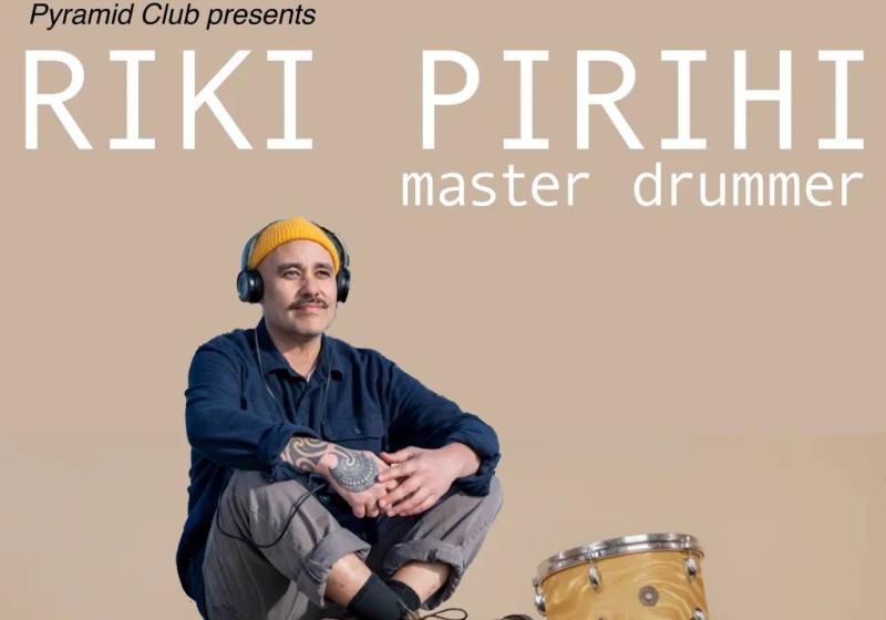Riki Pirihi sits on a yellow drumkit with a blank background