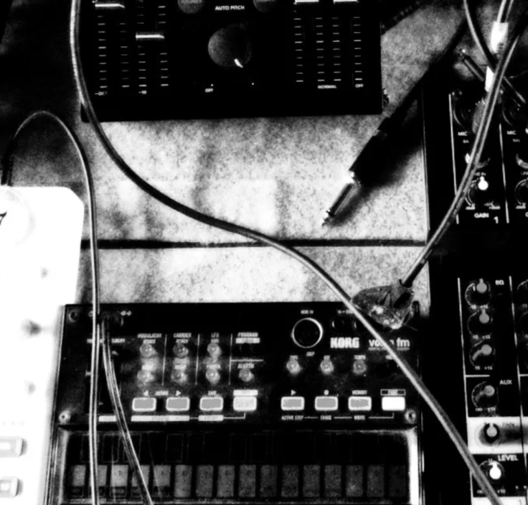A rough black and white image of electronic music gear