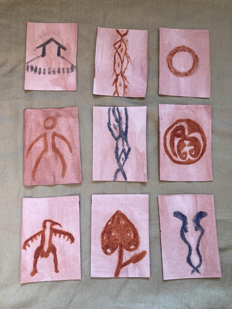 nine cards with ancient looking designs done in natural earth pigments - there texture is dusty and bold