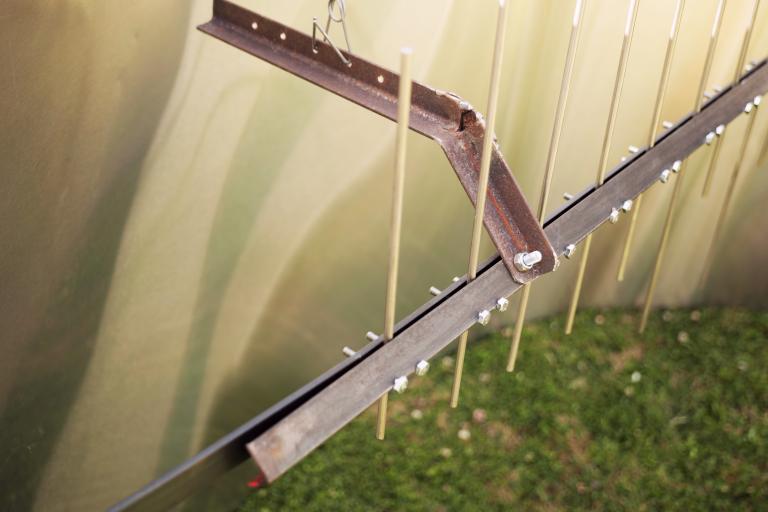 The tines held, clamped in between the angled steel bar.