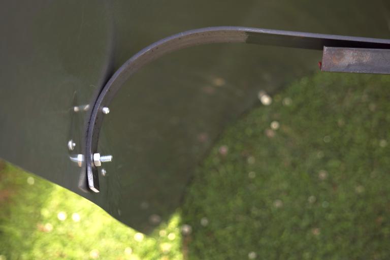 The pop riveted edge holding all the tension of the bent steel sheet